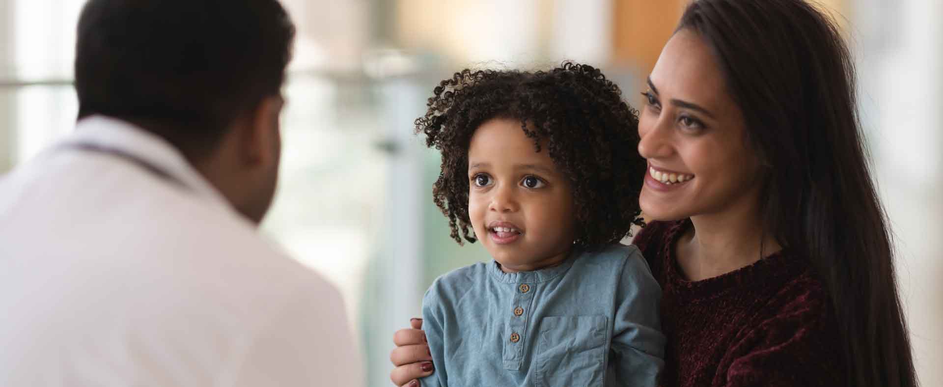 Mother with child talking with doctor